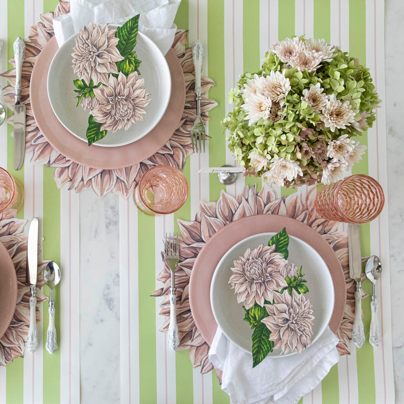 A floral table setting for two, with the Die-cut Dahlia Placemat on the Green & Pink Awning Stripe Runner.