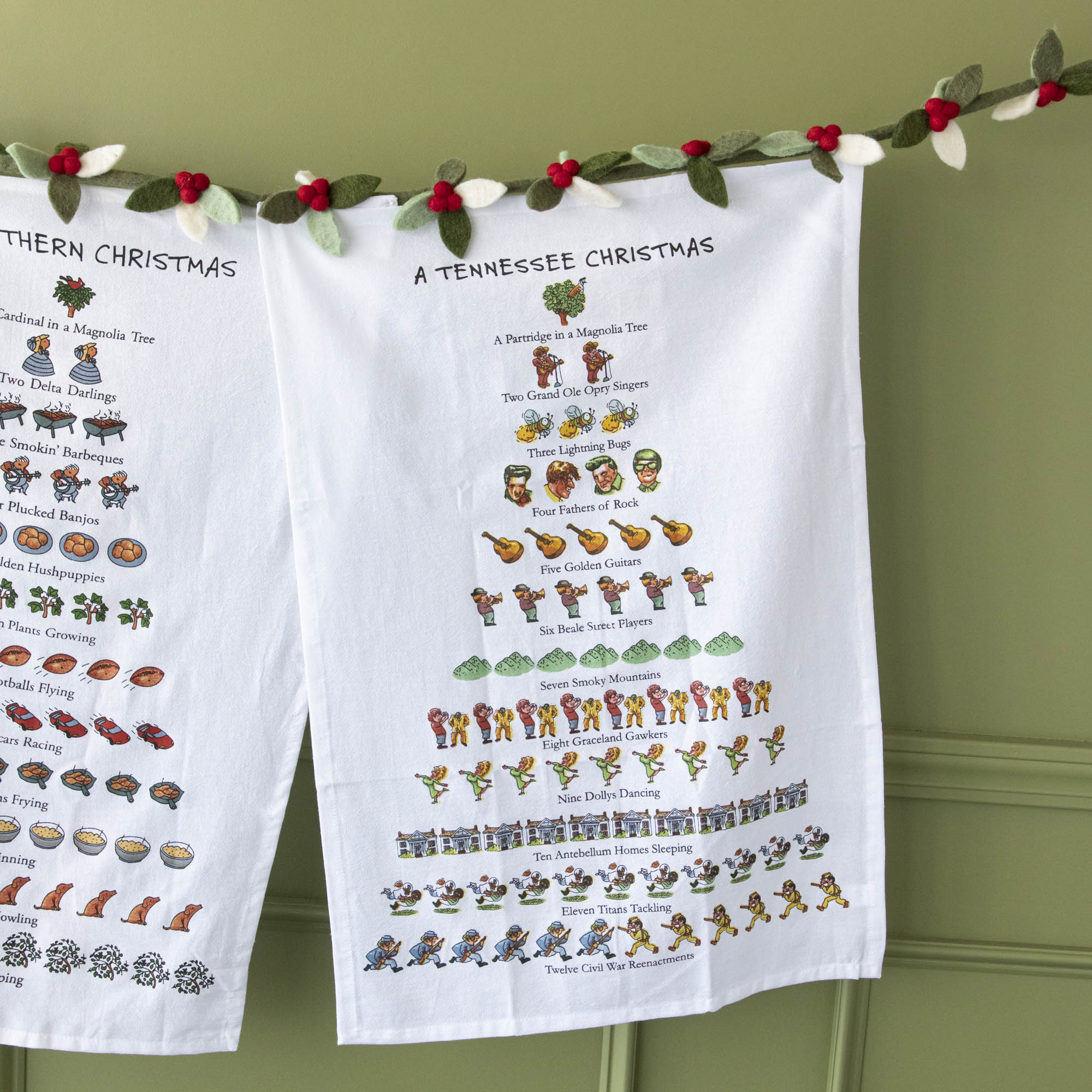 A Tennessee Christmas Tea Towel hung on a felt berry garland.