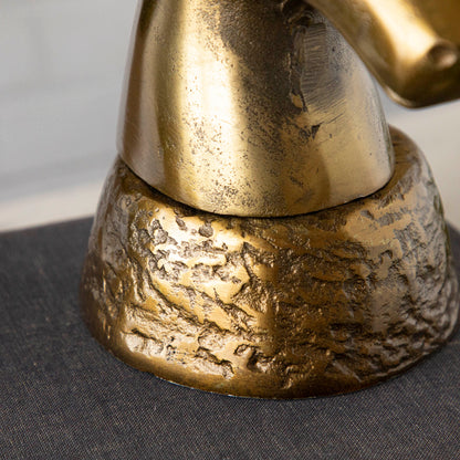 A close up of the Brass Deer Head showing its rustic base.