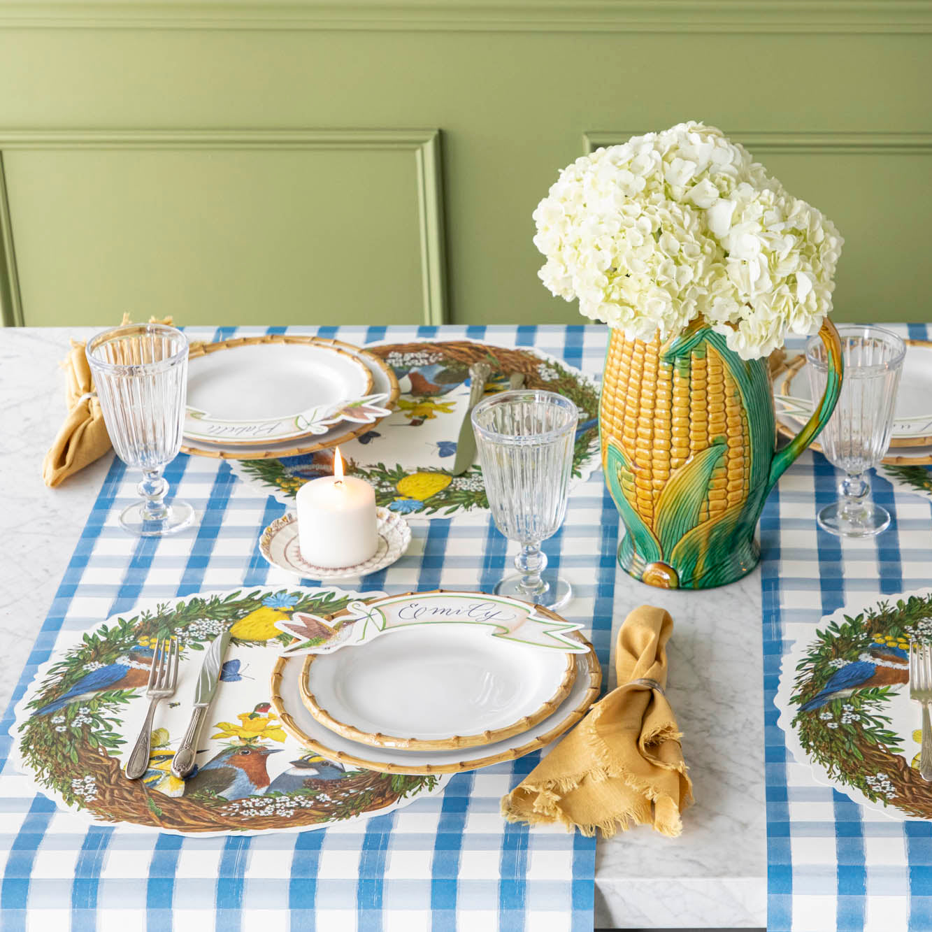 A spring table setting for four featuring the Die-cut Songbird Placemat under a place setting.