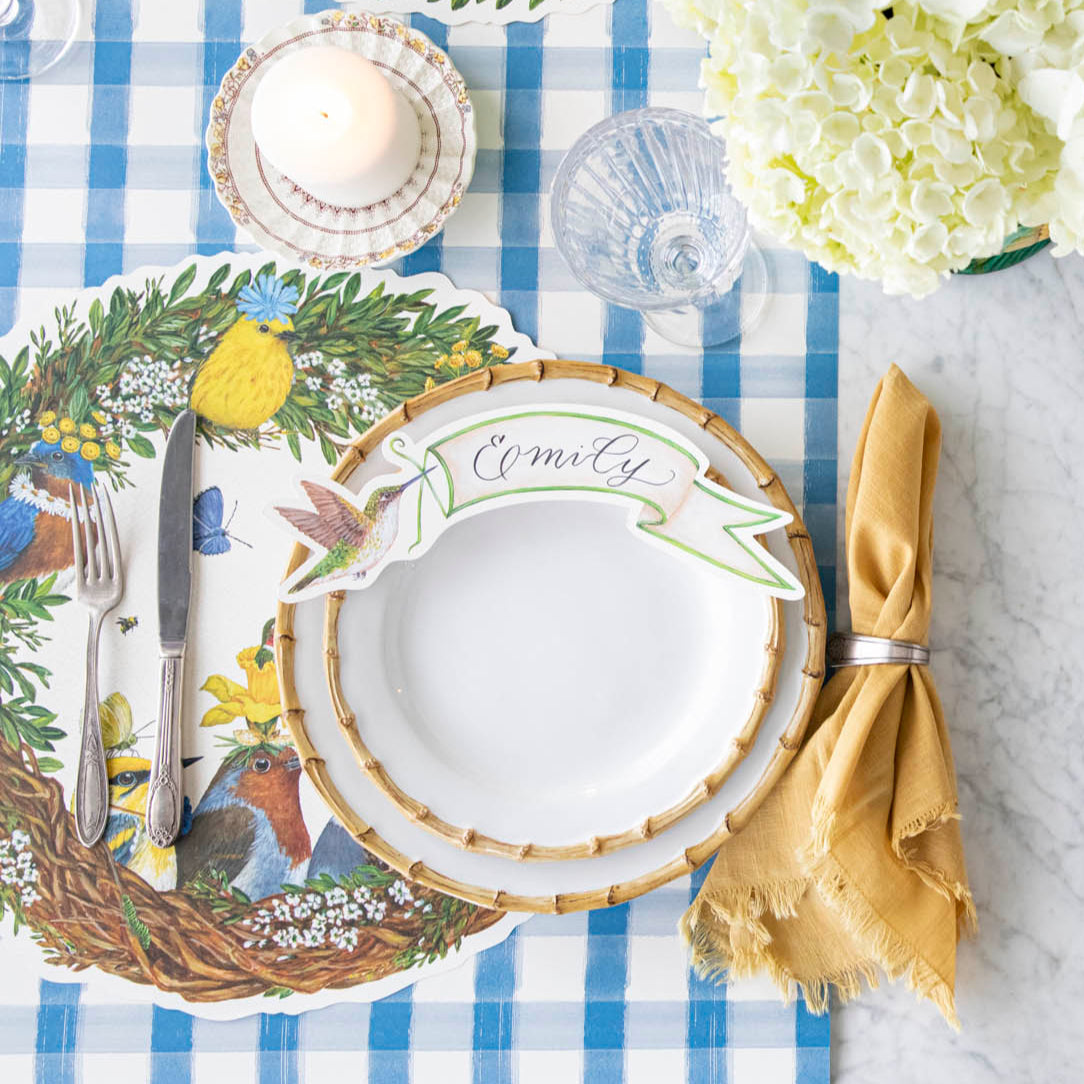 Songbird Wreath Placemat under a spring place setting.