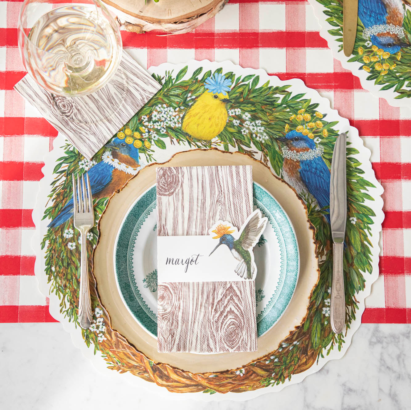 Songbird Wreath Placemat under a woodland place setting.