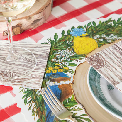 Songbird Wreath Placemat under a spring place setting.