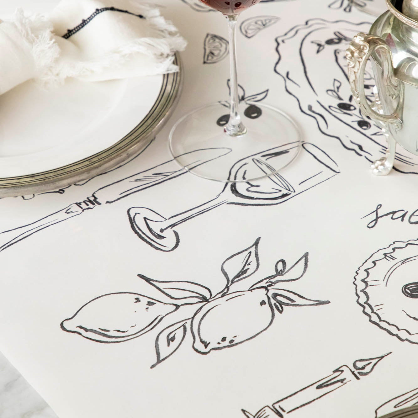 The Dinner Party Runner under an elegant table setting.