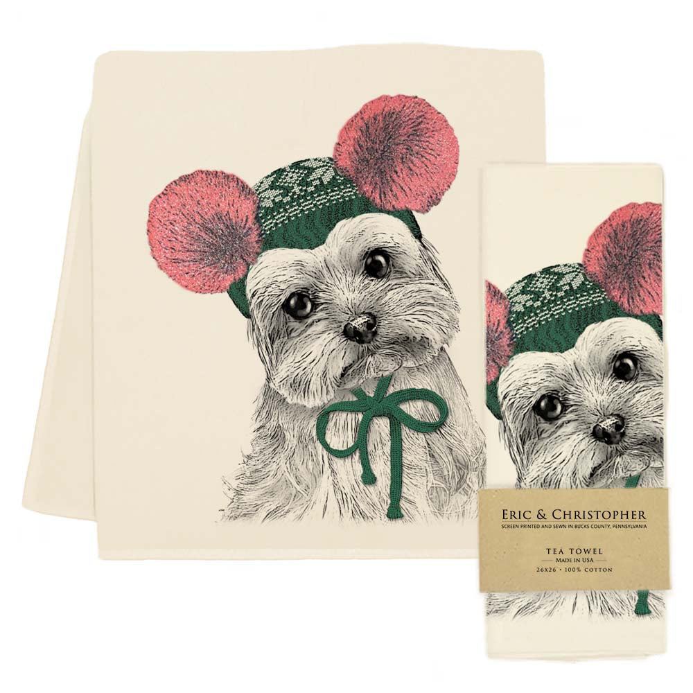 Tea towel with a yorkie dog that is wearing a winter hat with pom poms on it. 