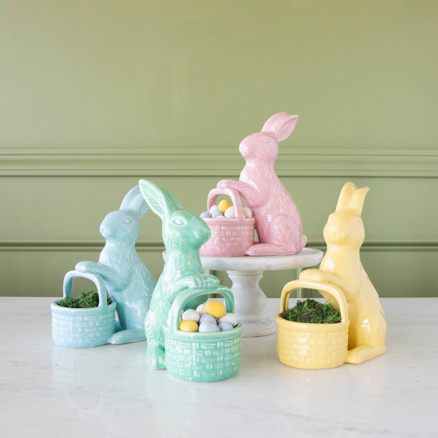 Ceramic Embossed Bunnies Holding Baskets filled with fake grass or chocolate eggs.