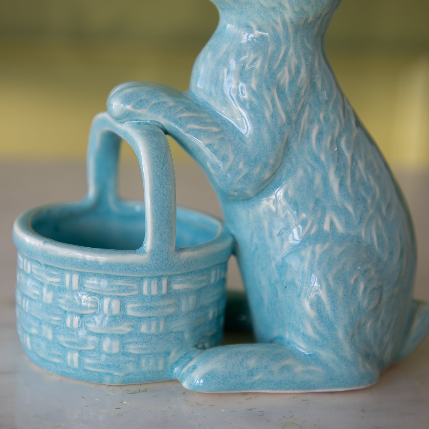 A bottom view of the Ceramic Embossed Bunny holding basket.