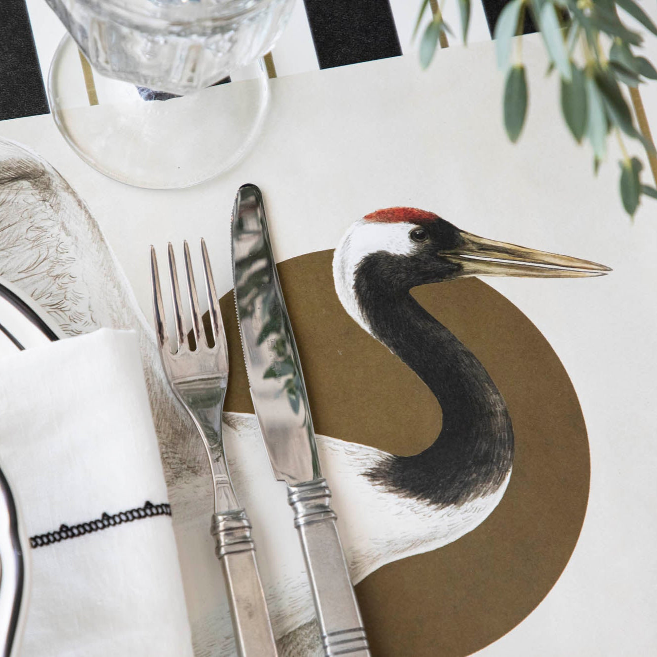 Close up of the Eastern Crane Placemat under an elegantly styled place setting.