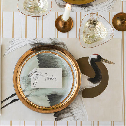 Eastern Crane Placemat on the Antique Gold Stripe Runner, styled on an elegant place setting for one.