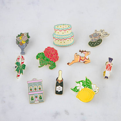 A set of Hester &amp; Cook Lemon Enamel Pins featuring fresh fruits and a lemon design.