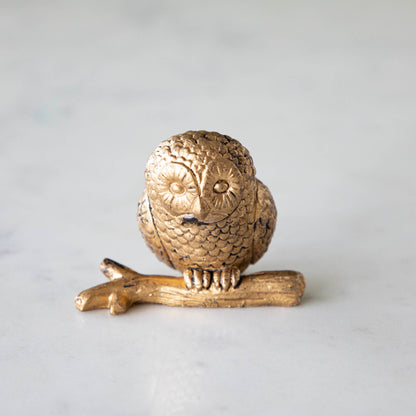 A  front view of the Owl Name Card Holder sitting on a branch, showing its line details that resemble fur and rustic  look.