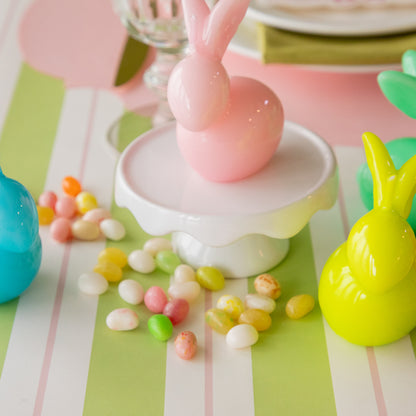 Bunny Candles in assorted colors styled in the center of two spring place settings.