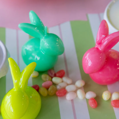 Bunny Candles in assorted colors styled in the center of two spring place settings.