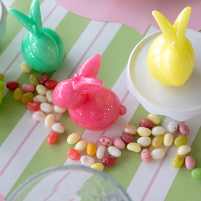 Bunny Candles in assorted colors styled in the center of two spring place settings.