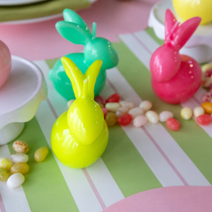 Bunny Candles in assorted colors styled in the center of two spring place settings.