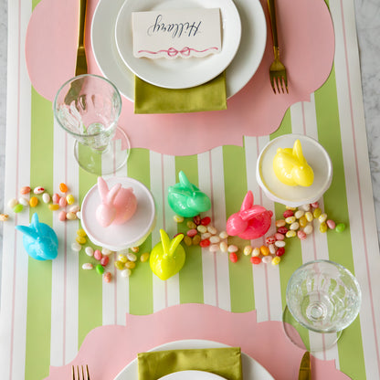 Bunny Candles in assorted colors styled in the center of two spring place settings.