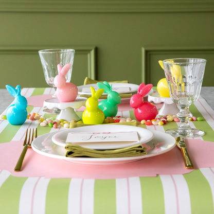 Bunny Candles in assorted colors styled in the center of two spring place settings.