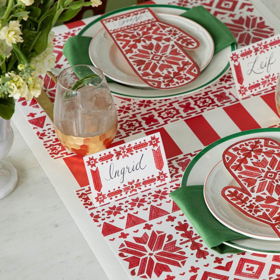 An elegant table setting with flowers, dinnerware and he Red Classic Stripe Runner underneath.