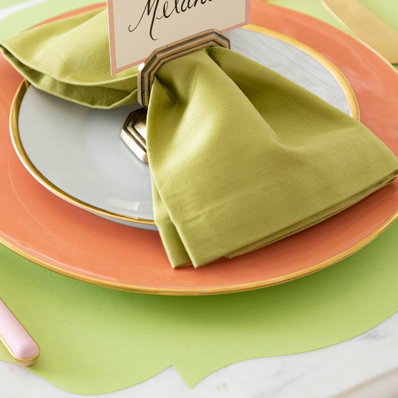 Die-cut Bright Green French Frame Placemat under a brightly colored place setting, on the Green &amp; Pink Awning Stripe Runner.