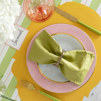 Die-cut Marigold French Frame Placemat under a place setting for one, on a spring themed table.