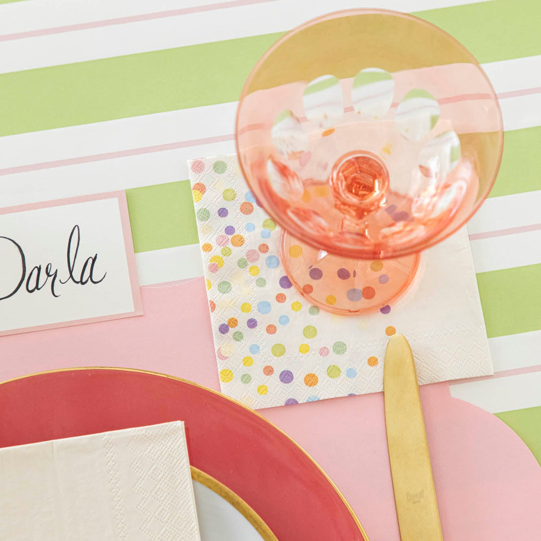 Confetti Sprinkles  Cocktail Napkin under an empty glass on a place setting.