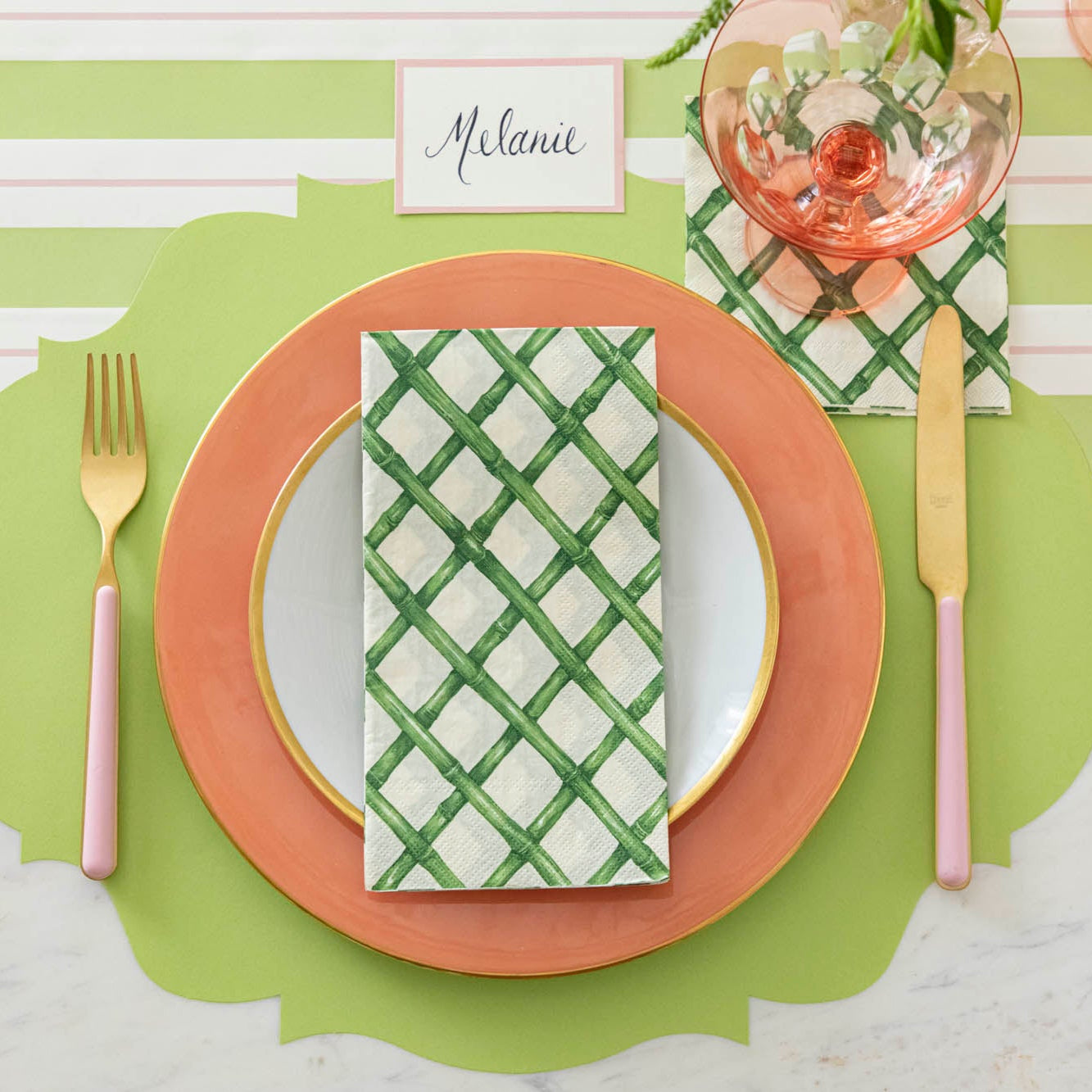 The Green Lattice Cocktail Napkin under an empty glass and guest napkin centered on a plate, on a place setting for one.