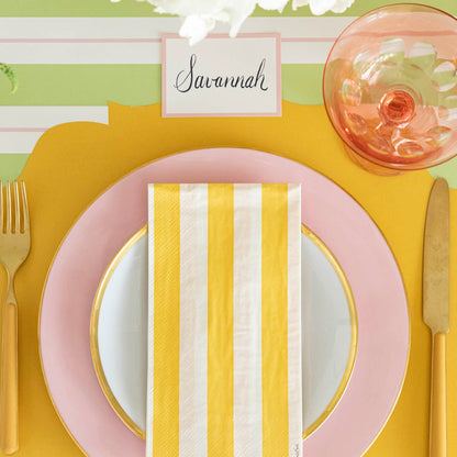 Pink Frame Place Card with &quot;Savannah&quot; written on it, behind a place setting for one.