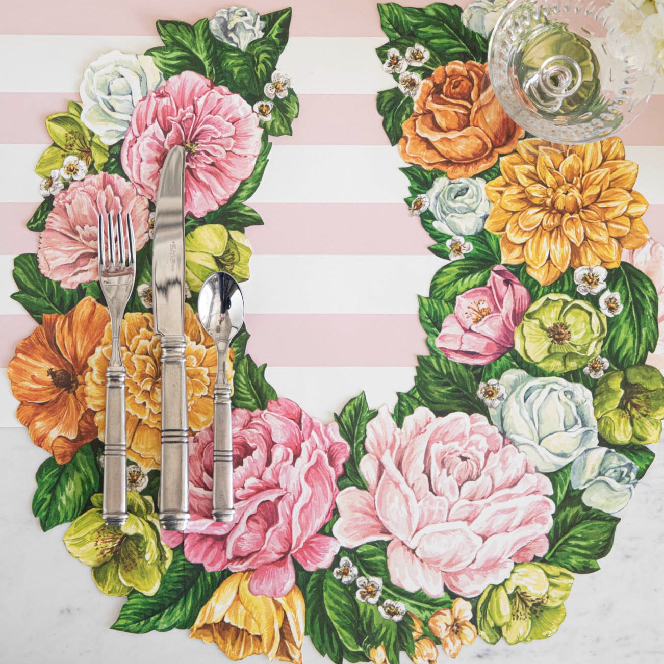 The Die-cut Derby Wreath Placemat under a bright floral place setting sans plate, from above.