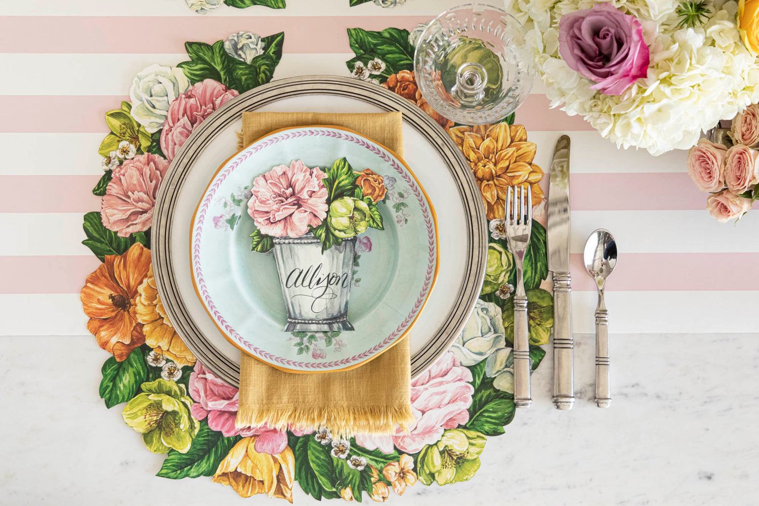 Top-down view of an elegant floral place setting featuring a Garden Derby Place Card labeled &quot;Allison&quot; laying flat on the plate.