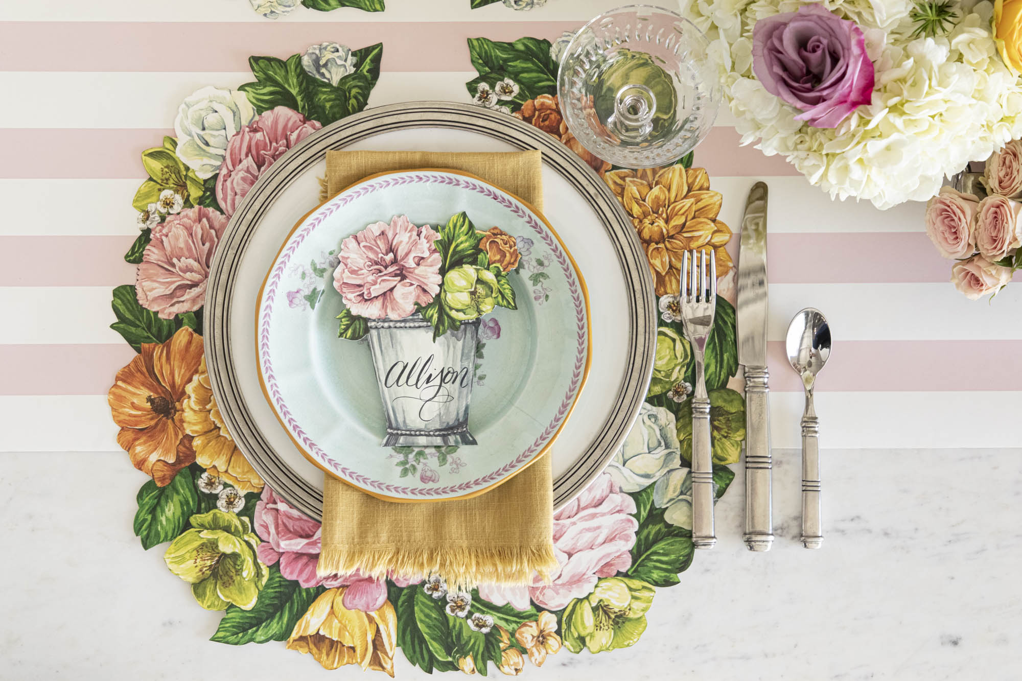 Top-down view of an elegant floral place setting featuring a Garden Derby Place Card labeled &quot;Allison&quot; laying flat on the plate.