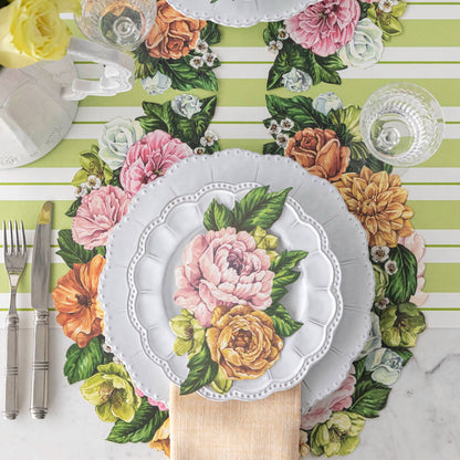 The Die-cut Derby Wreath Placemat under a bright floral place setting, from above.