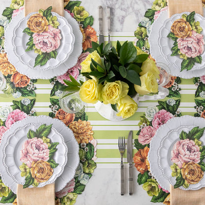 The Die-cut Derby Wreath Placemat under a bright floral table setting for four, from above.