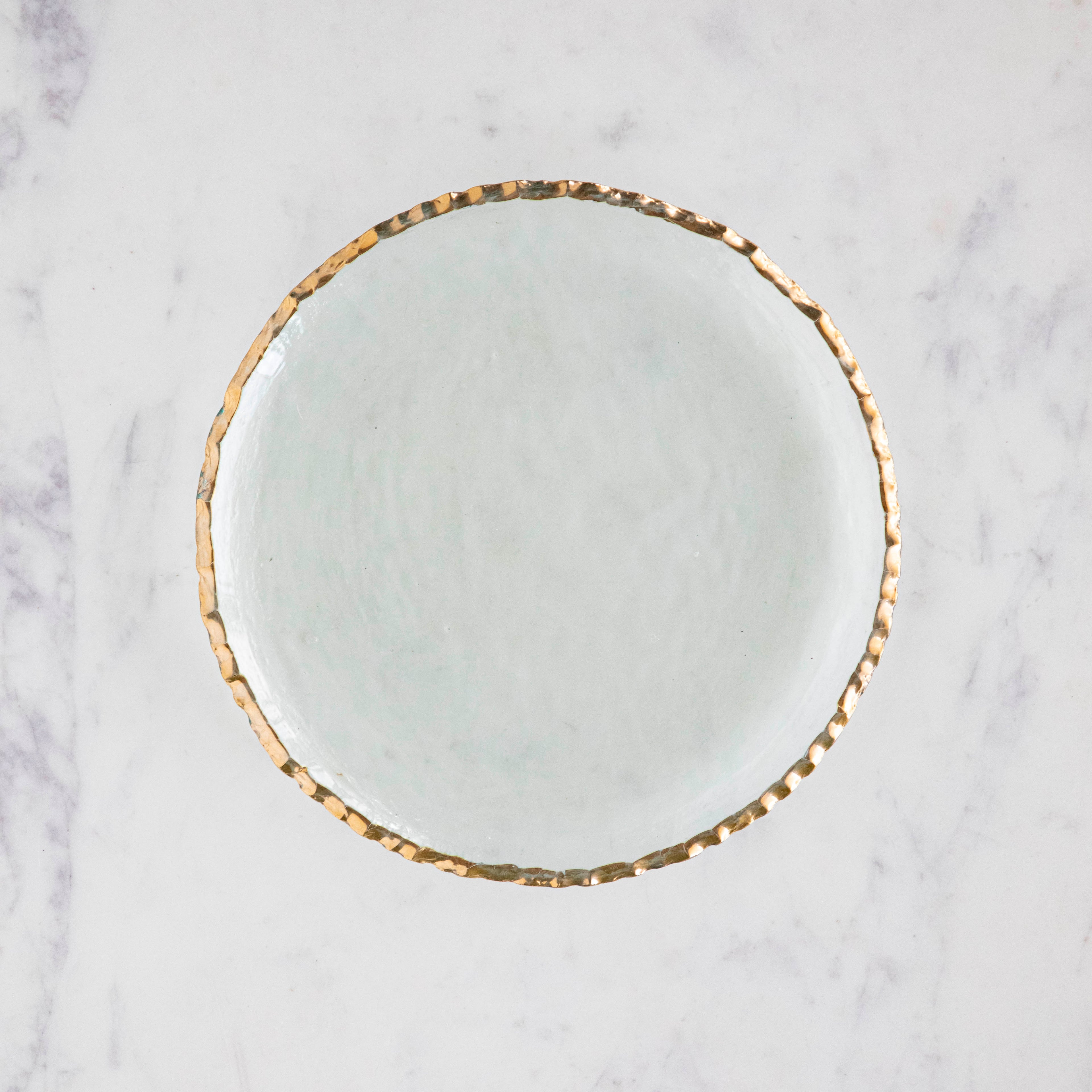 Annie Glass Edgy Salad Plate, adorned with a 24-karat gold band in an edgy shape, on a marble table.