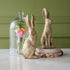 Gold Leaf Rabbits styled on a table with a jar of flowers behind it.