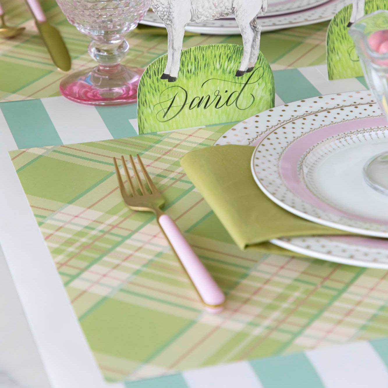 Bright Green Plaid Placemat under a place setting with gold and pink dinnerware.