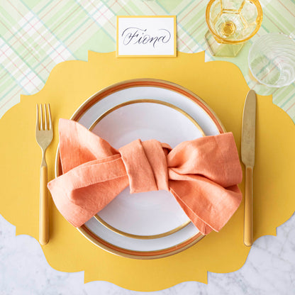 A colorful place setting with the Bright Green Plaid Runner under the Die-cut Marigold French Frame Placemat and place setting.