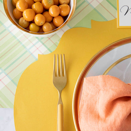 The Die-cut Marigold French Frame Placemat under a colorful place setting.