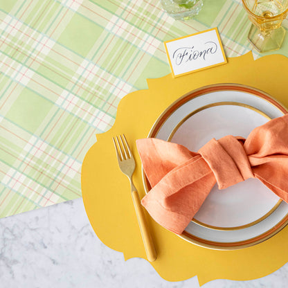 A colorful place setting with the Bright Green Plaid Runner under the Die-cut Marigold French Frame Placemat.