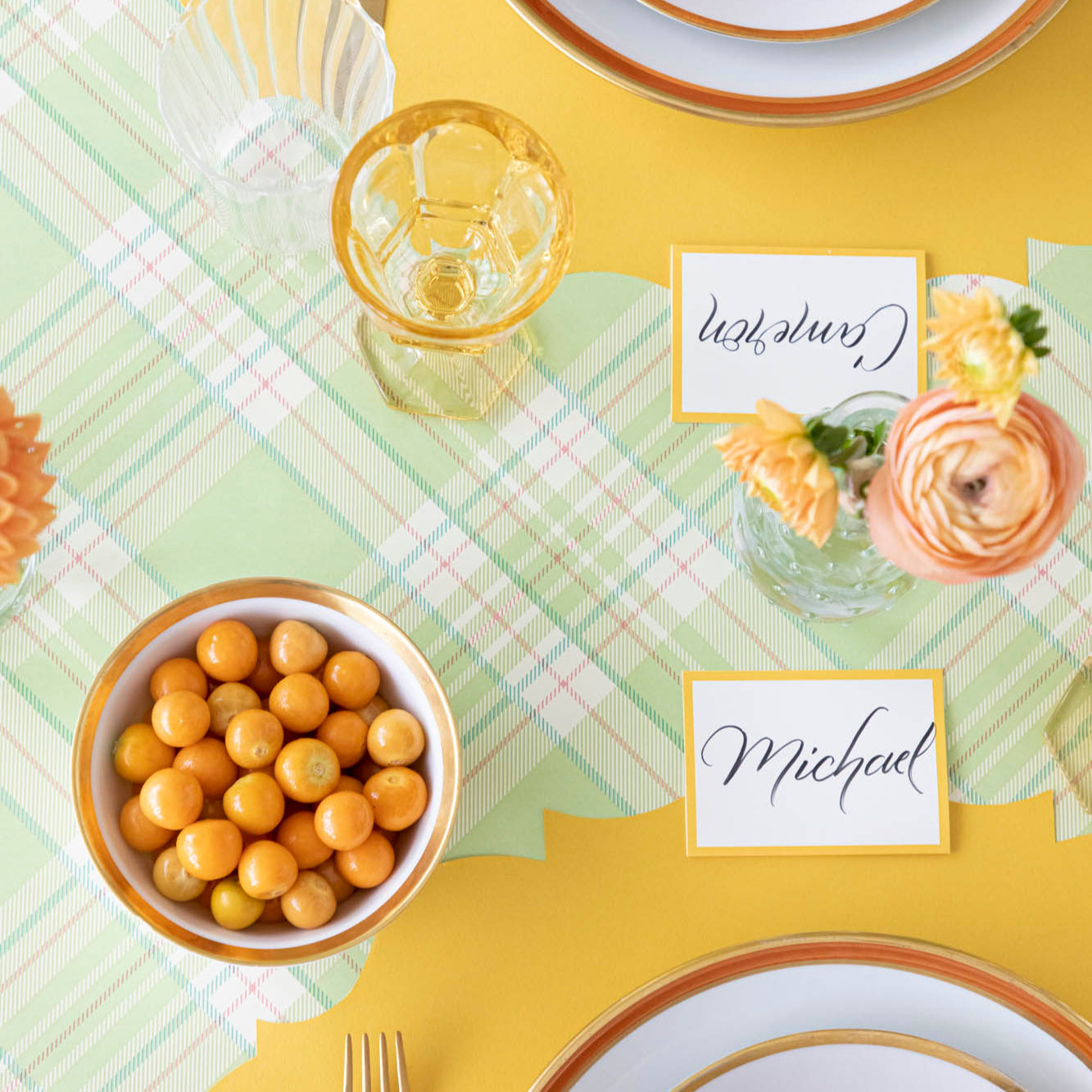 A colorful table setting with the Bright Green Plaid Runner under the Die-cut Marigold French Frame Placemat.