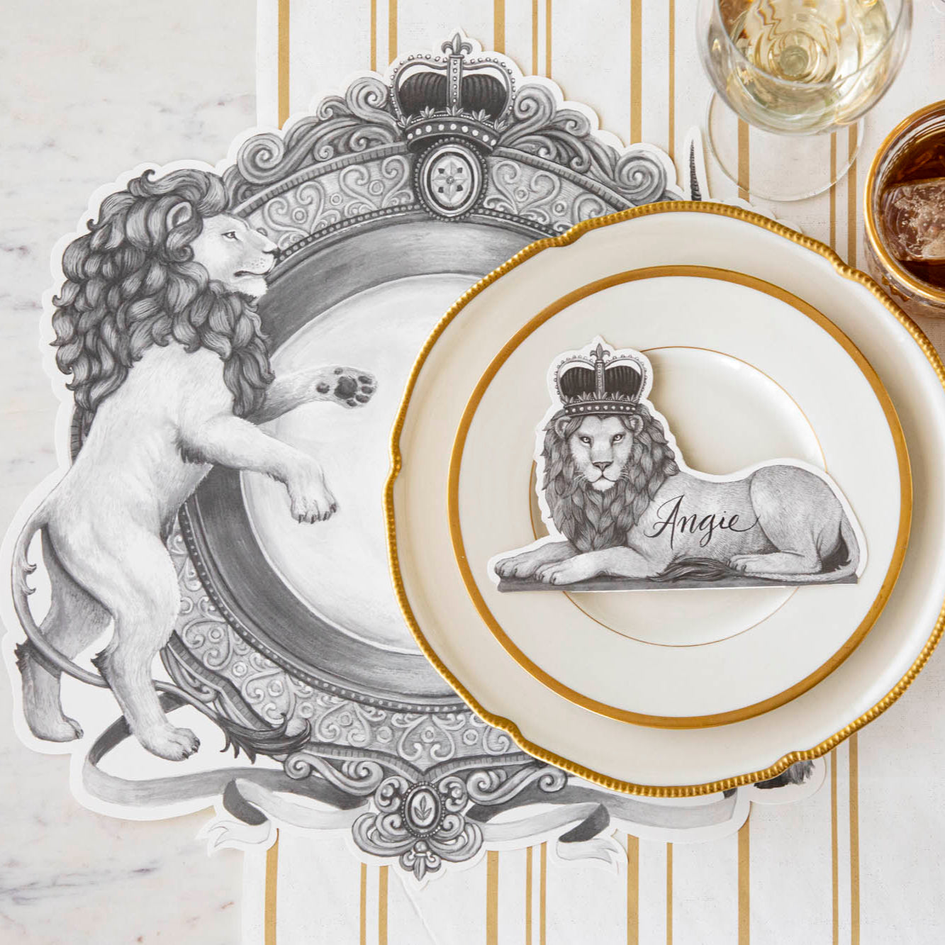 Die-cut H&C Regal Crest Placemat on the Antique Gold Stripe Runner, styled elegantly with the Regal Lion Place Card, on a table setting for one.