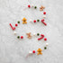 Felt Gingerbread Candy Garland featuring gingerbread men, candy canes and poms on a candy stripe string.