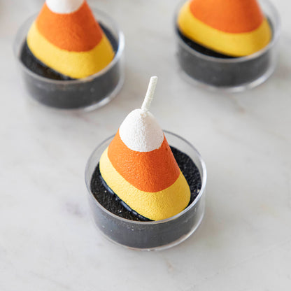 Candy corn theme tea light on a marble table with other candy corn tea lights.