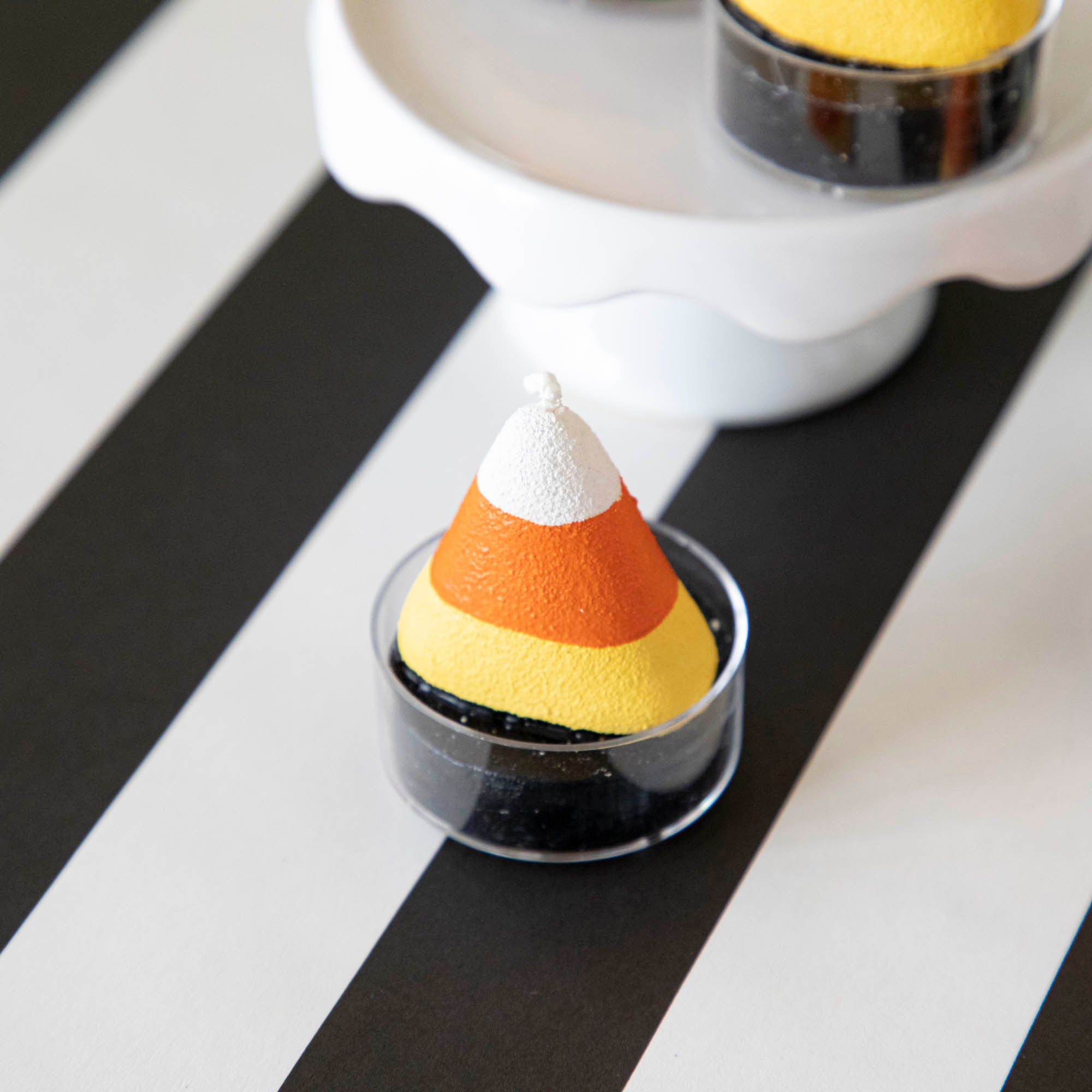 Candy corn theme tea light on a black stripe runner.