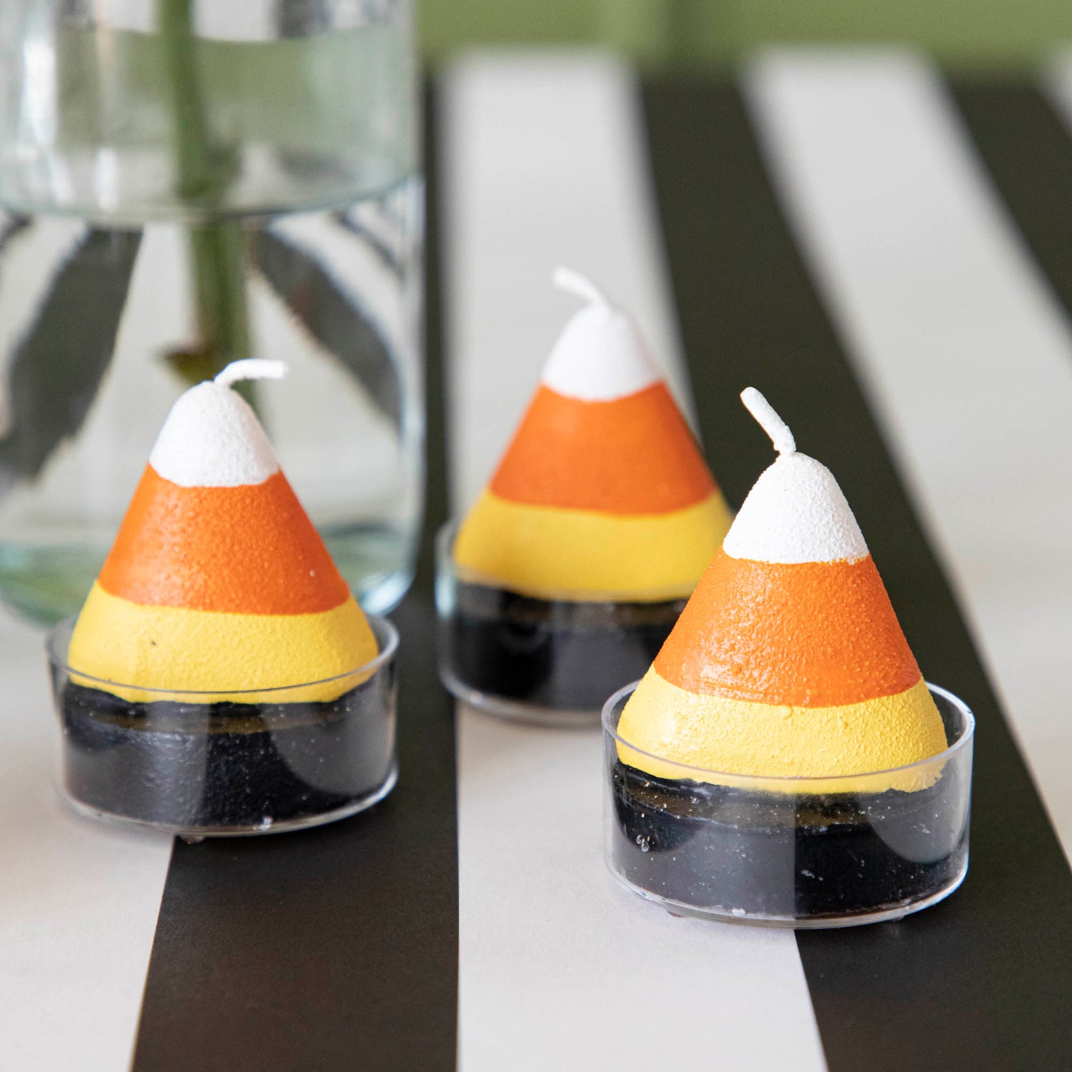 Candy corn themed tea light candles on a black stripe runner.