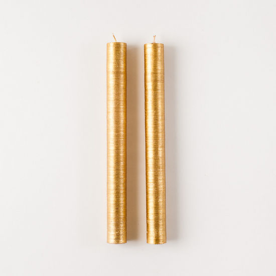 Two Glitterville Goldleaf Taper Candle Set of 2 on a white background, adding an elegant touch.