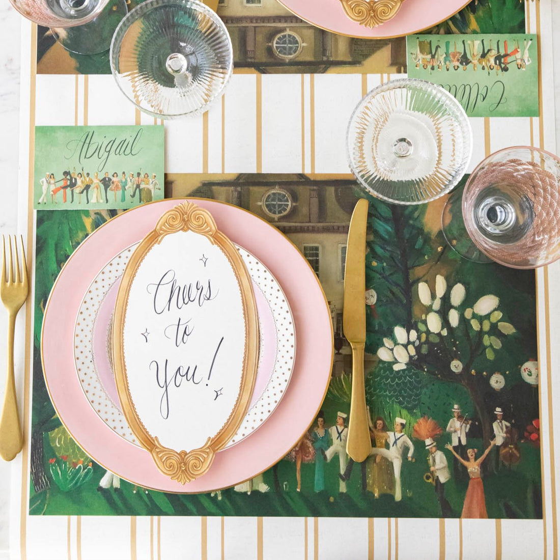 The High Kick Placemat on an elegant table setting featuring the High Kick Place Card and Antique Gold Frame Table Card on the dinner plate.