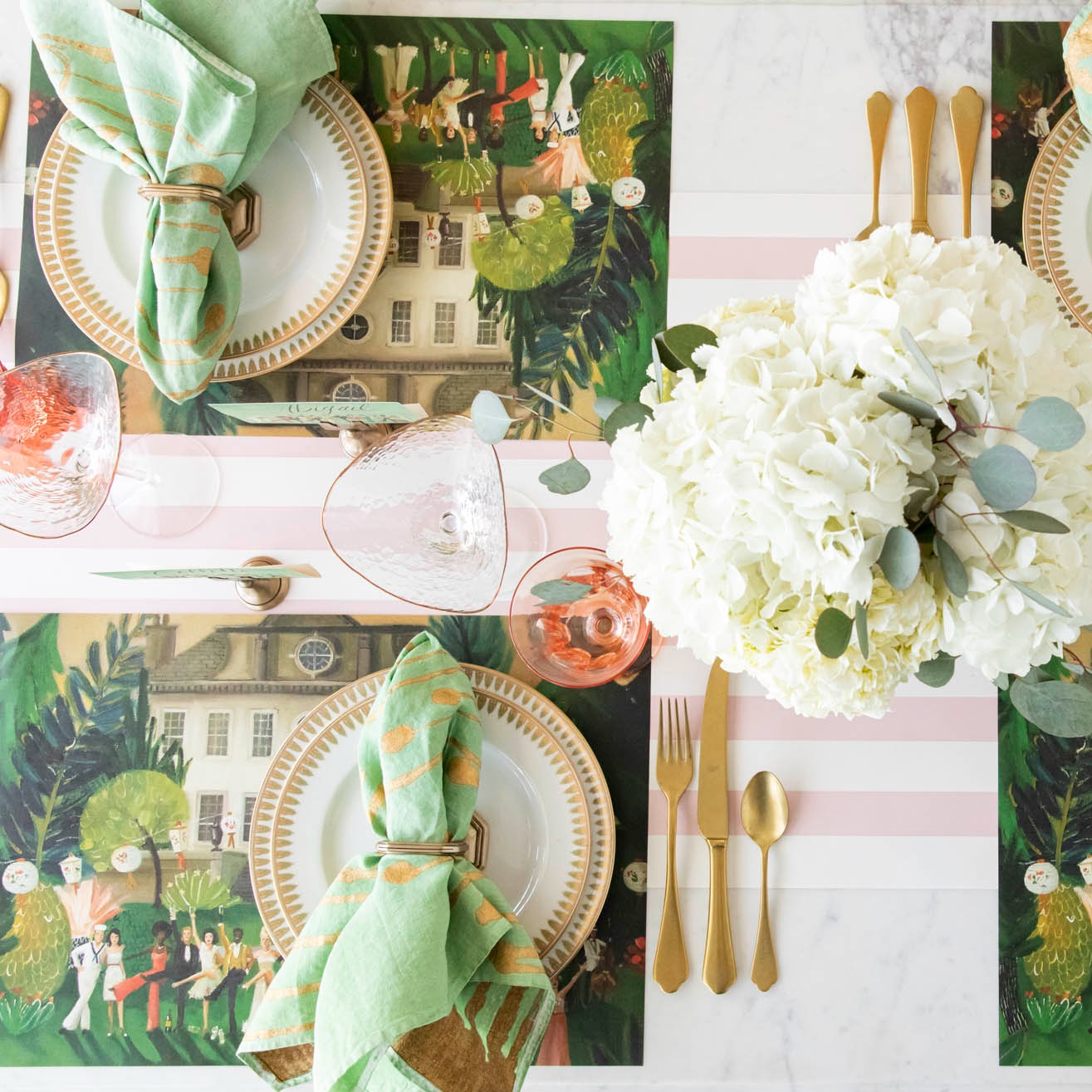 A top-down view of an elegant tablescape featuring High Kick Place Cards behind each plate.