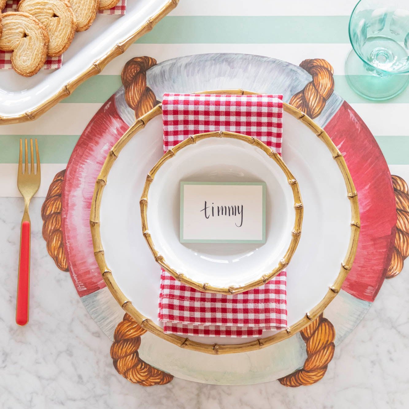 An elegant nautical themed table setting featuring the Juliska Bamboo Dinnerware on the Die-cut Life Preserver Placemat.