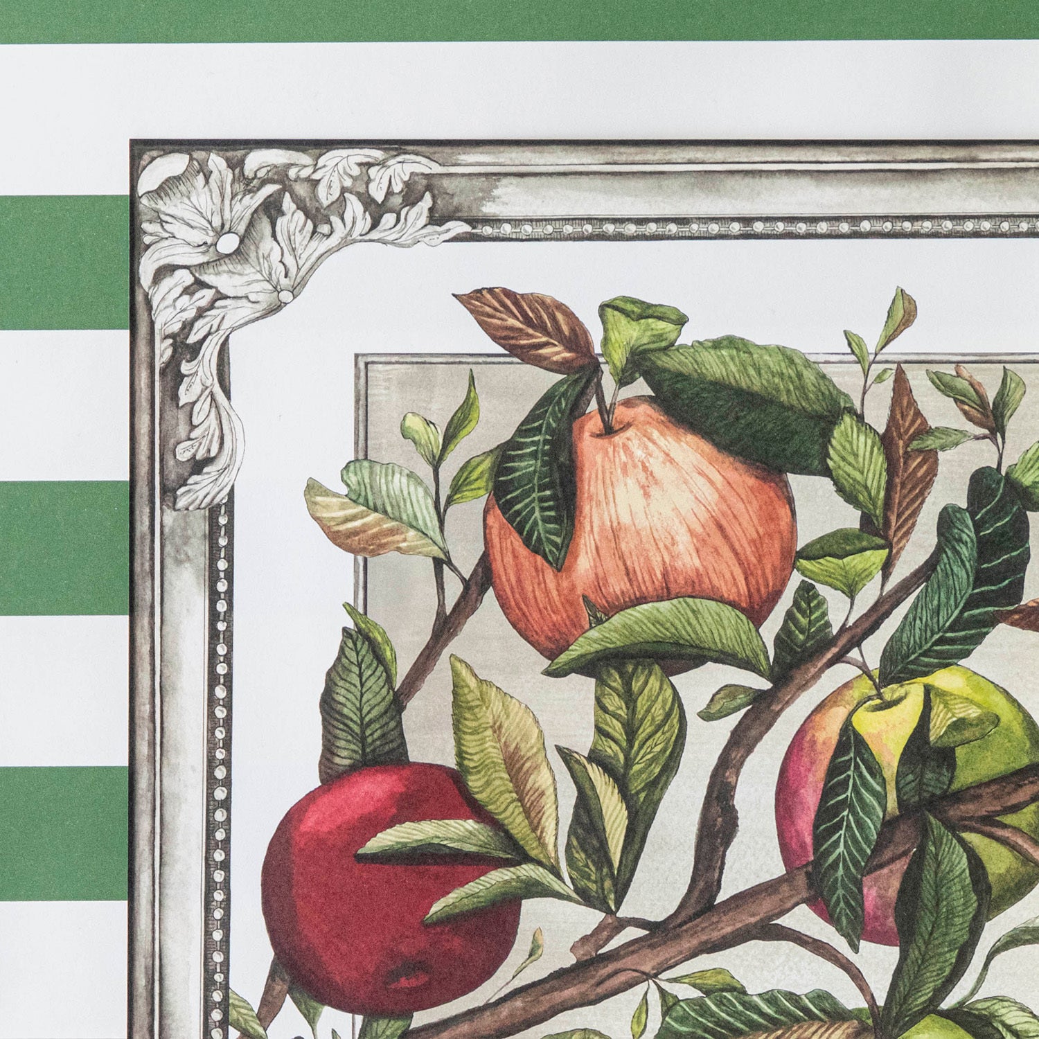 Close-up of the upper left corner of the Heirloom Apples Placemat, showing illustrated apples, leaves, and decorative frame in detail.