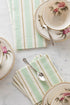 A table setting with Seafoam & Gold Awning Stripe Napkins by Hester & Cook, accompanied by teacups and saucers and a spoon.